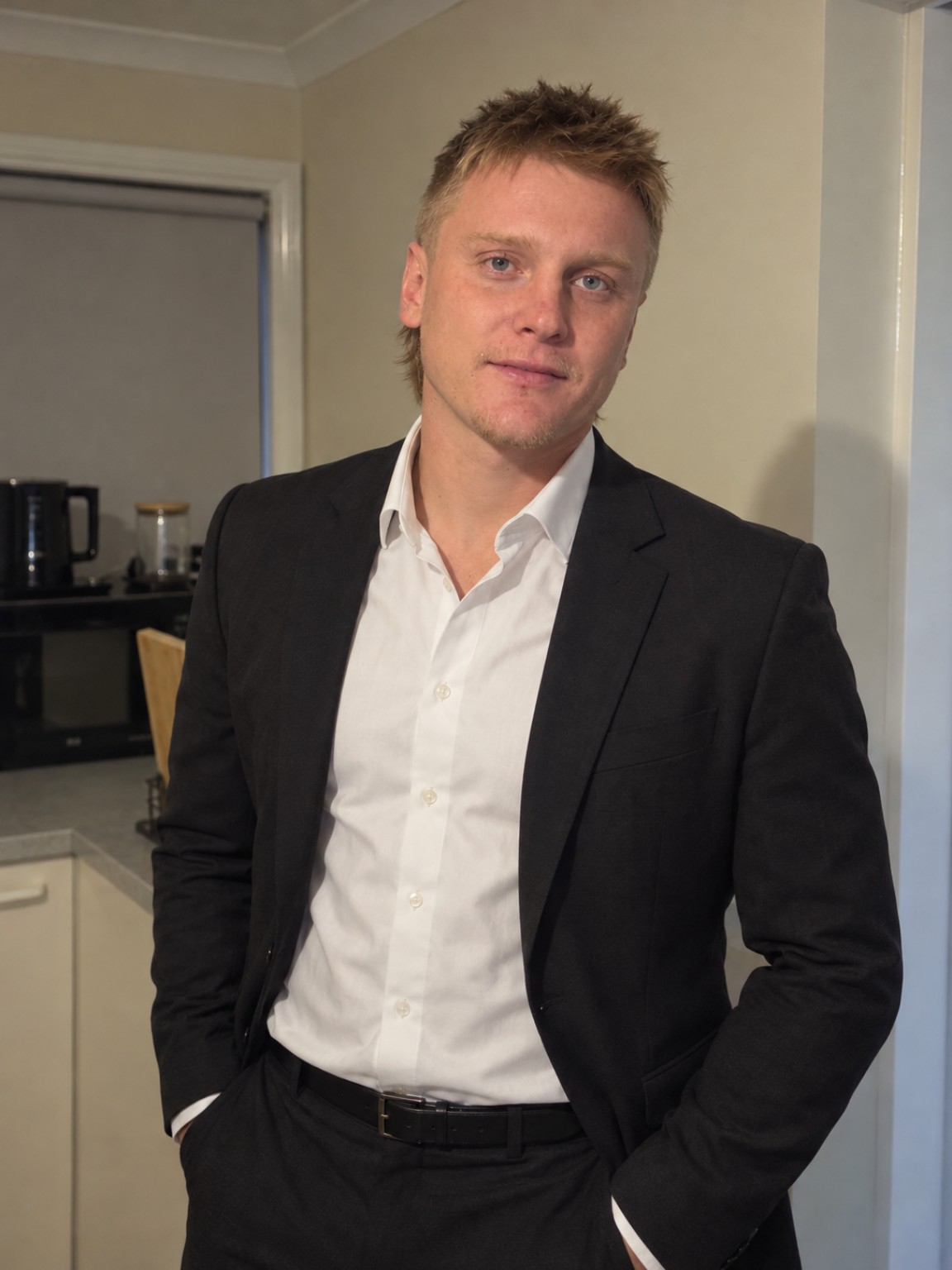 Portrait of Kyle Ashlin wearing a dark jacket and white shirt